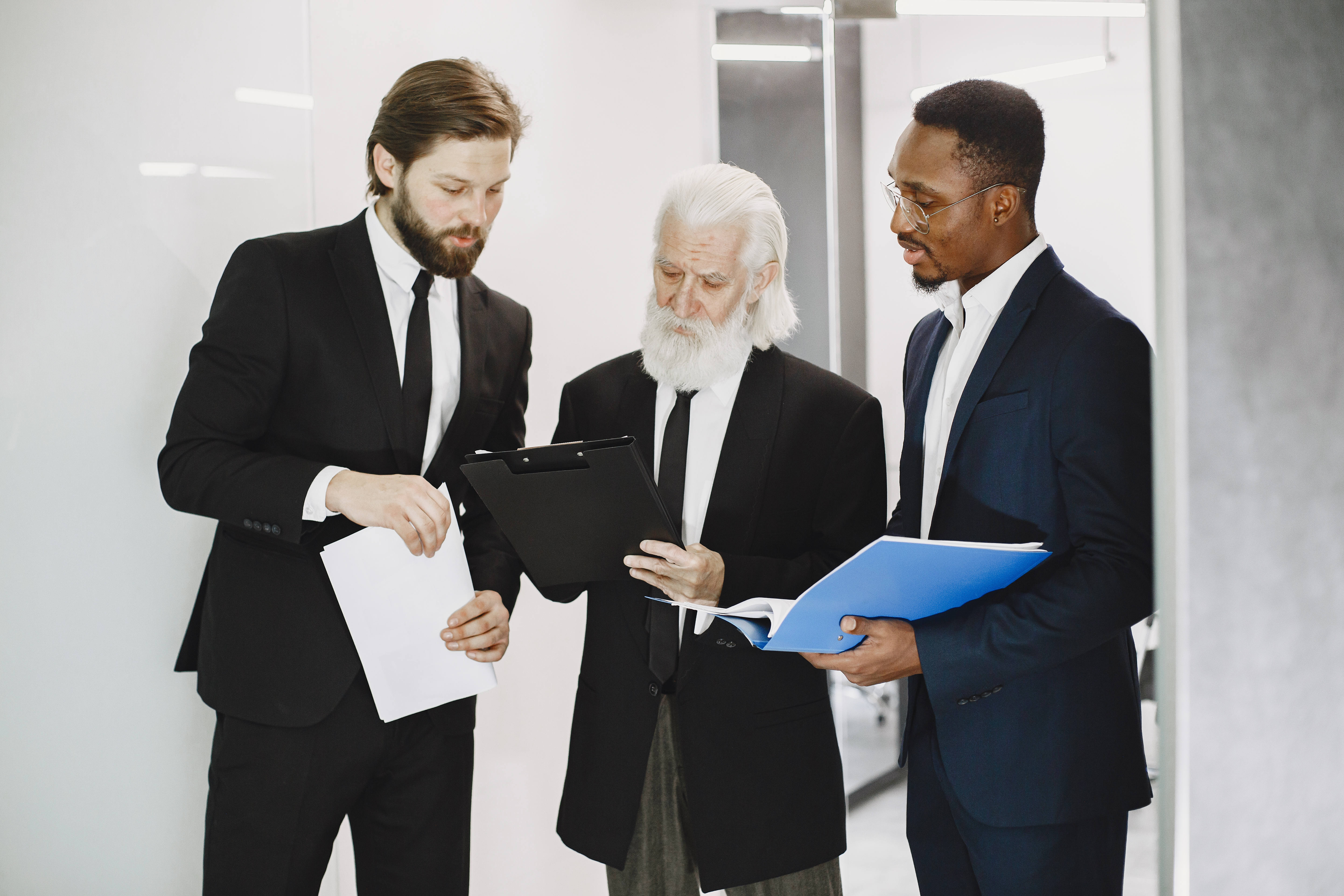 Three business professionals reviewing documents together.