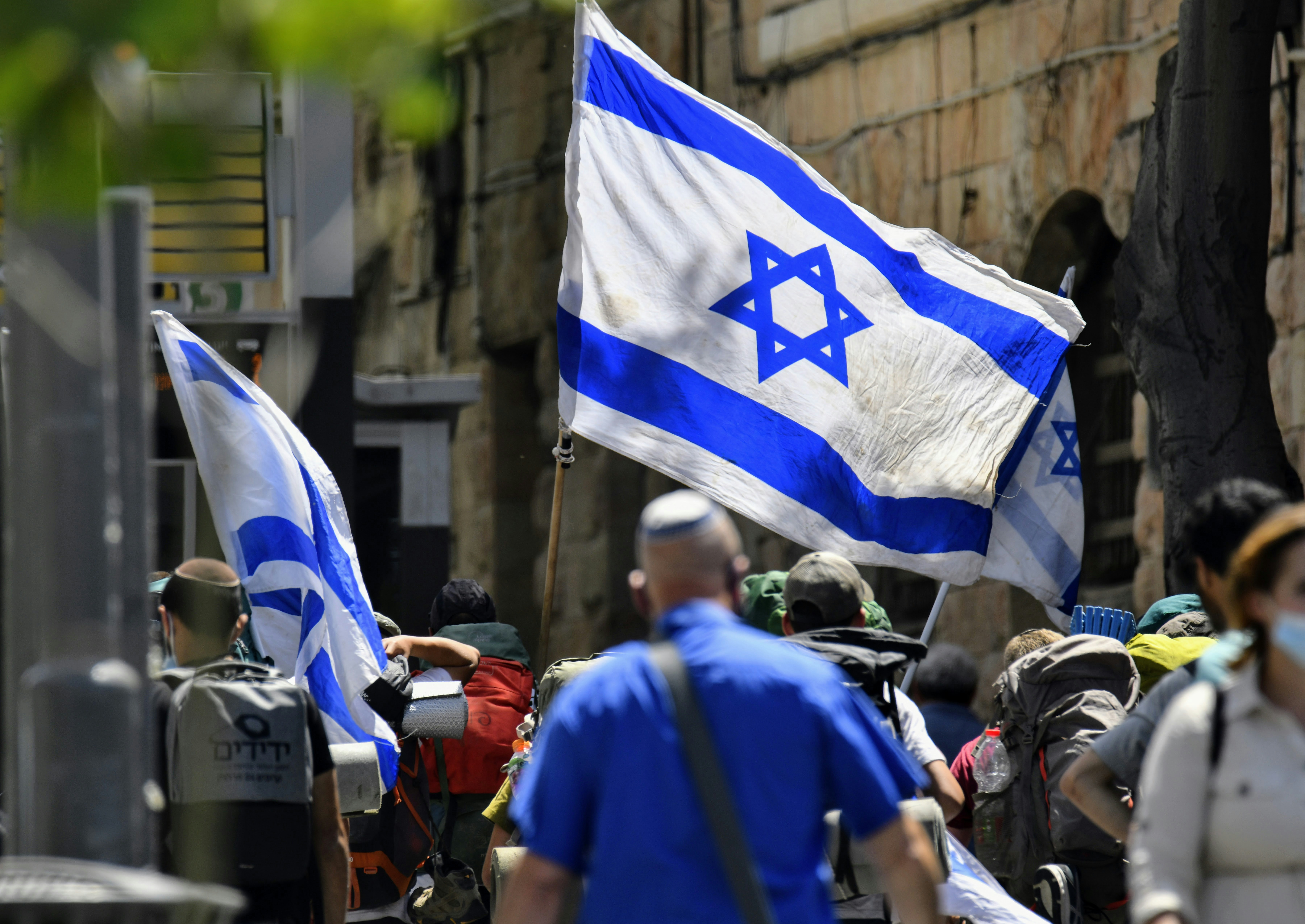 People carrying Israeli flags during a demonstration.