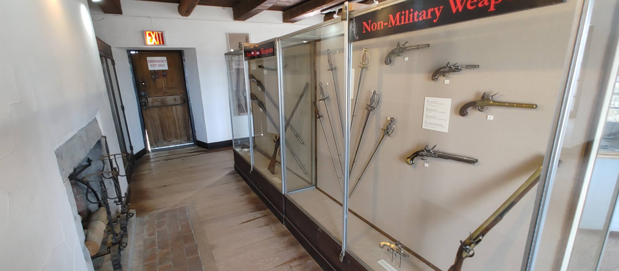 Museum exhibit cases displaying historical weapons and other artifacts at Fort Ticonderoga