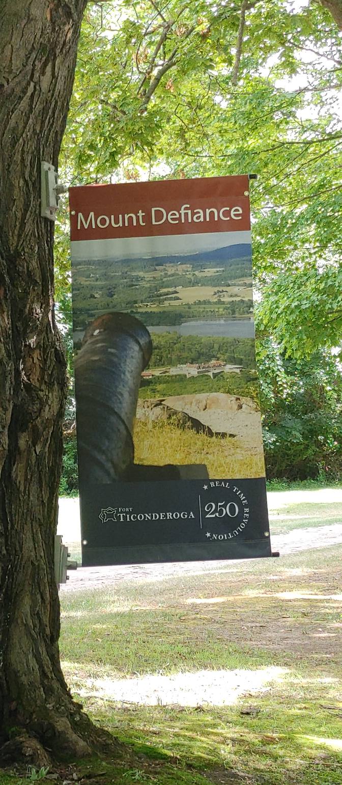 Fort Ticonderoga banner showing a cannon overlooking Mount Defiance