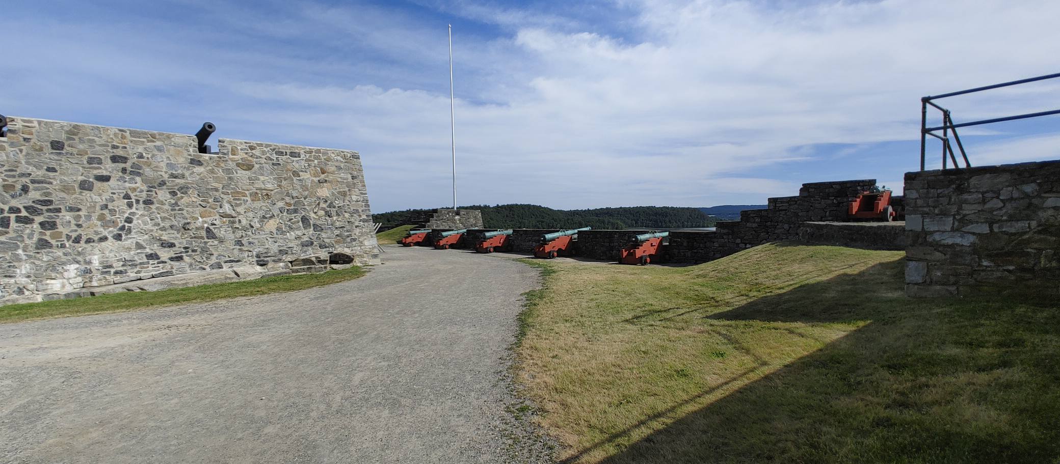 A cannon viewed from behind with the lake and mountains beyond